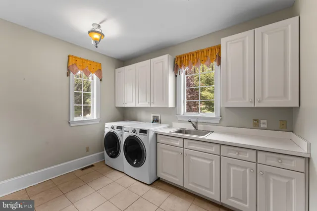 a view of an empty room with a chandelier fan