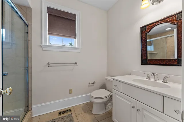 a spacious bathroom with a granite countertop tub sink and mirror