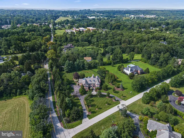 an aerial view of a house with yard