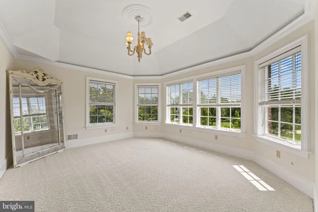 a spacious bedroom with a bed and a window