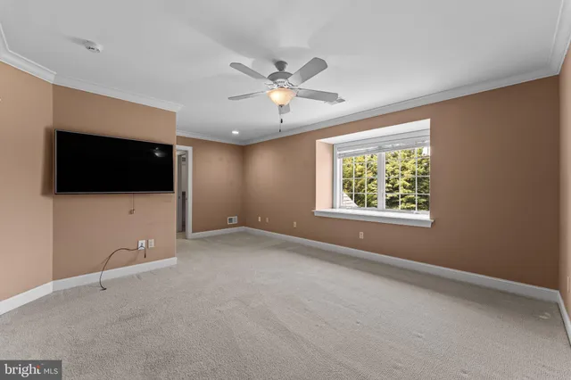a view of a hallway with a table and chairs