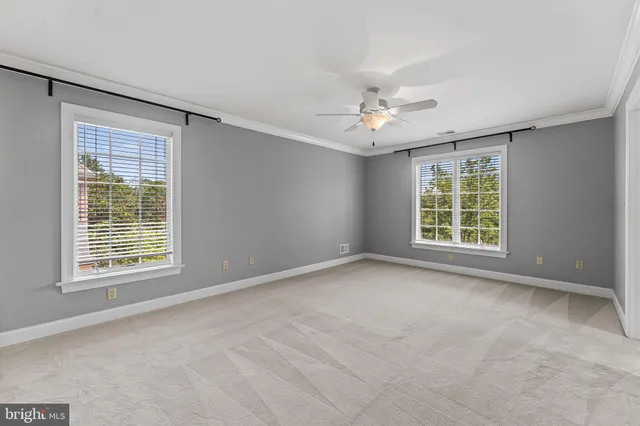 a balcony with wooden floor and yard in the back