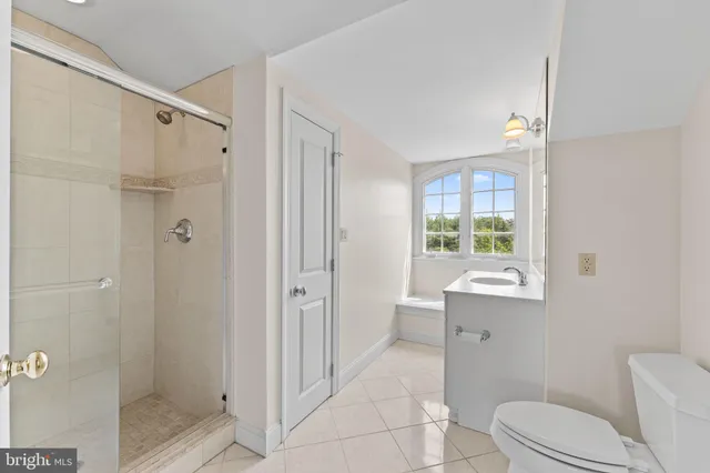 an aerial view of a house with a garden and lake view