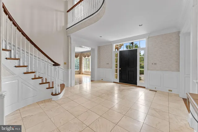 a view of an entryway with wooden floor and stairs