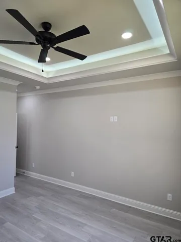 a bathroom with a granite countertop sink a toilet a large mirror and shower