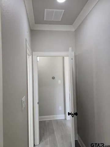 a white kitchen with a sink a stove a dining table and chairs