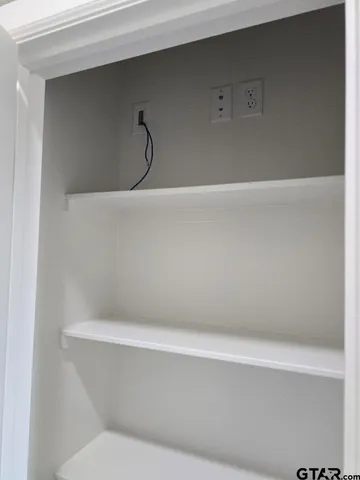 a spacious bathroom with a granite countertop sink and a mirror