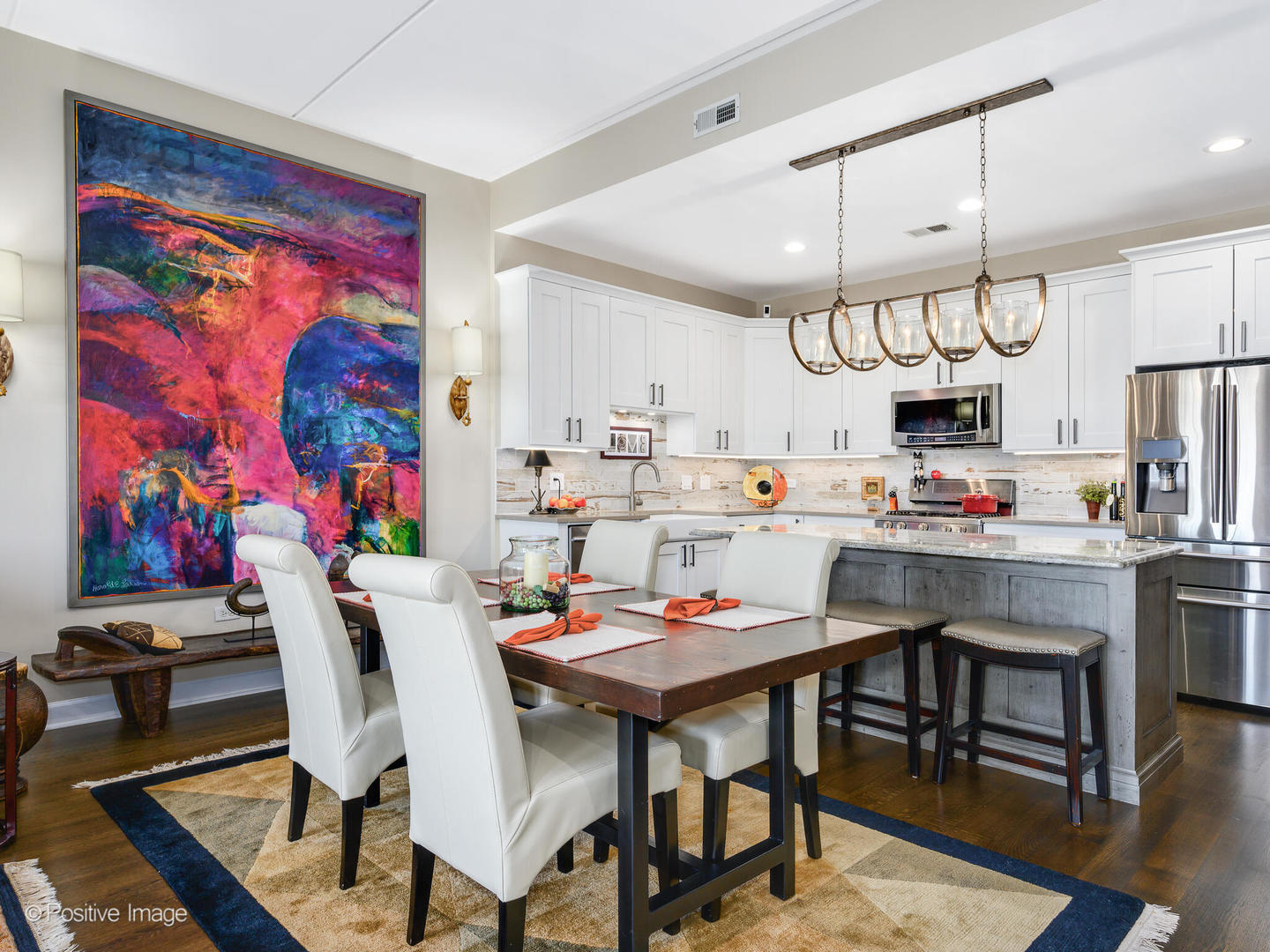 1909 West Diversey Parkway, Unit 501 Chicago, IL 60614 - Photo 7 of 21 a kitchen with stainless steel appliances kitchen island granite countertop a dining table chairs and a refrigerator