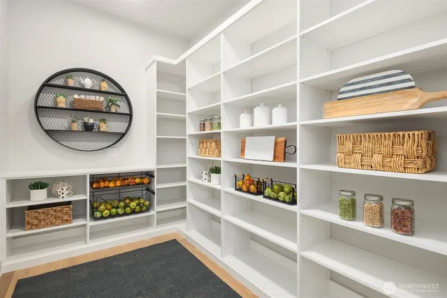 a view of a room with shelves and book shelf