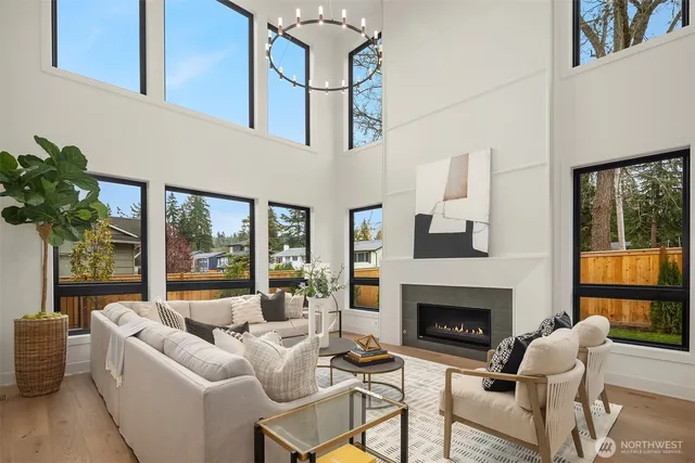a living room with furniture a large window and a fireplace
