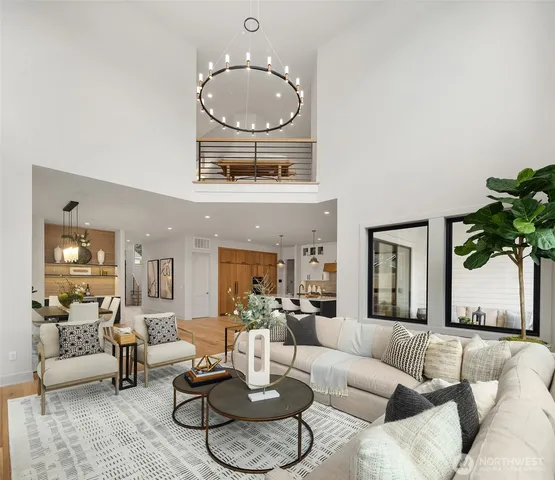 a living room with furniture a glass top table and a chandelier
