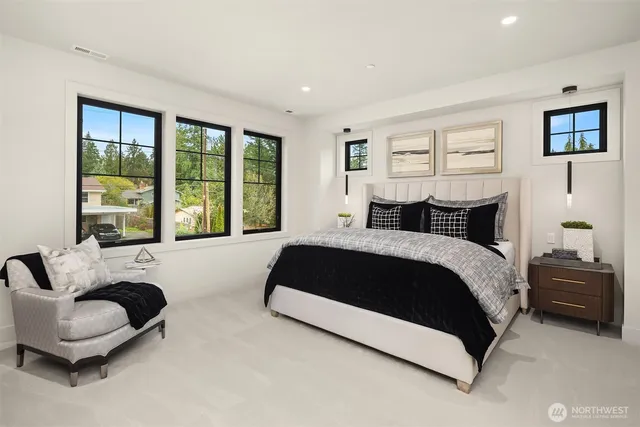 a bedroom with a large bed and a large window