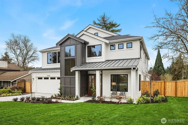 a front view of a house with a yard and trees