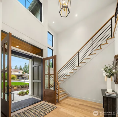 a view of entryway and hall with wooden floor