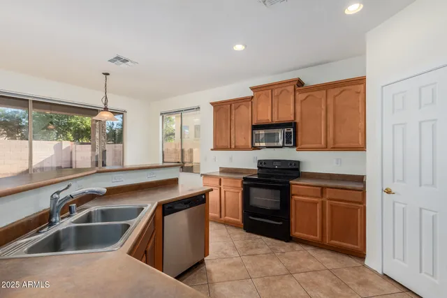 a kitchen with a sink stove and microwave