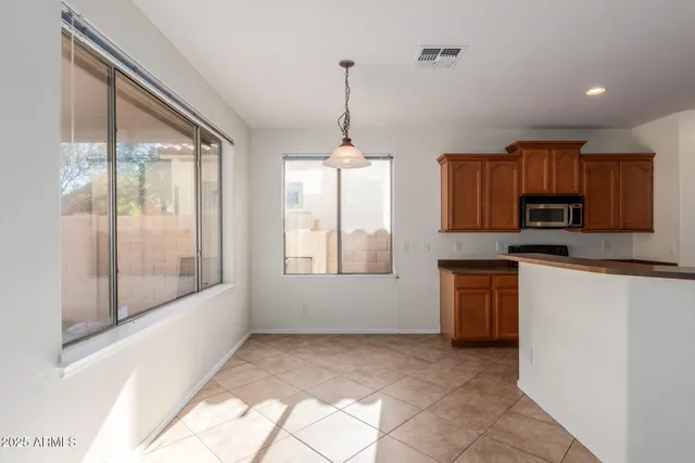 a kitchen with window and cabinets