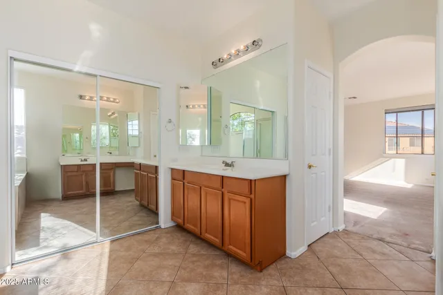 a large bathroom with a glass door shower and sink