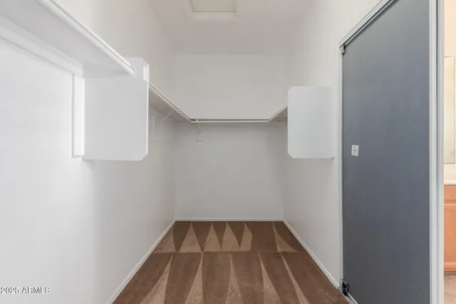 a view of a room with wooden floor and bench