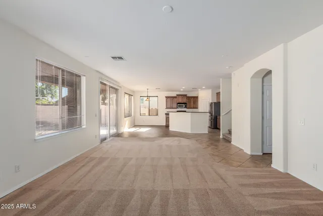 a view of a livingroom with wooden floor and windows