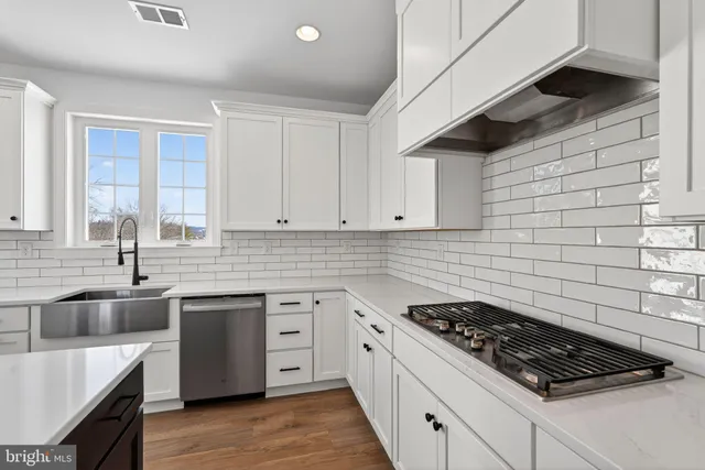a kitchen that has a sink and a stove