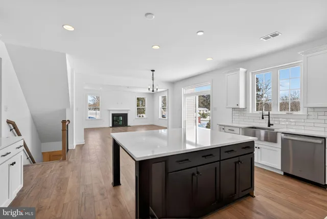 a kitchen with granite countertop a sink counter top space and stainless steel appliances