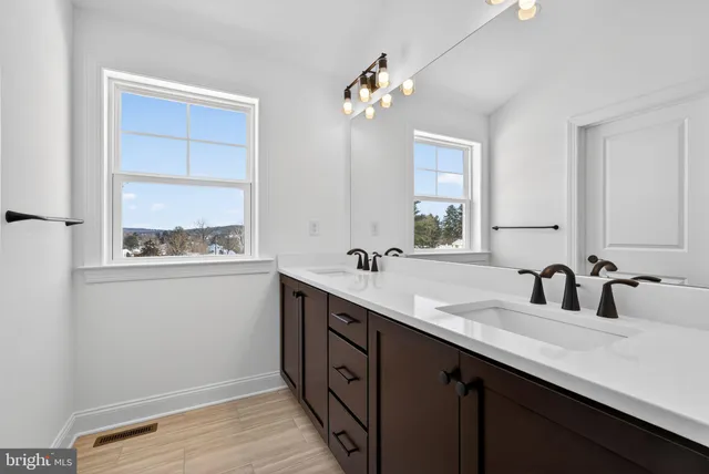 a bathroom with a shower and a sink