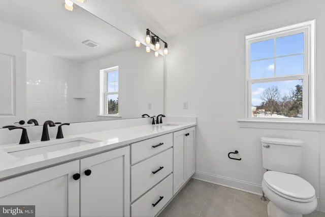 a white bath tub sitting next to a toilet