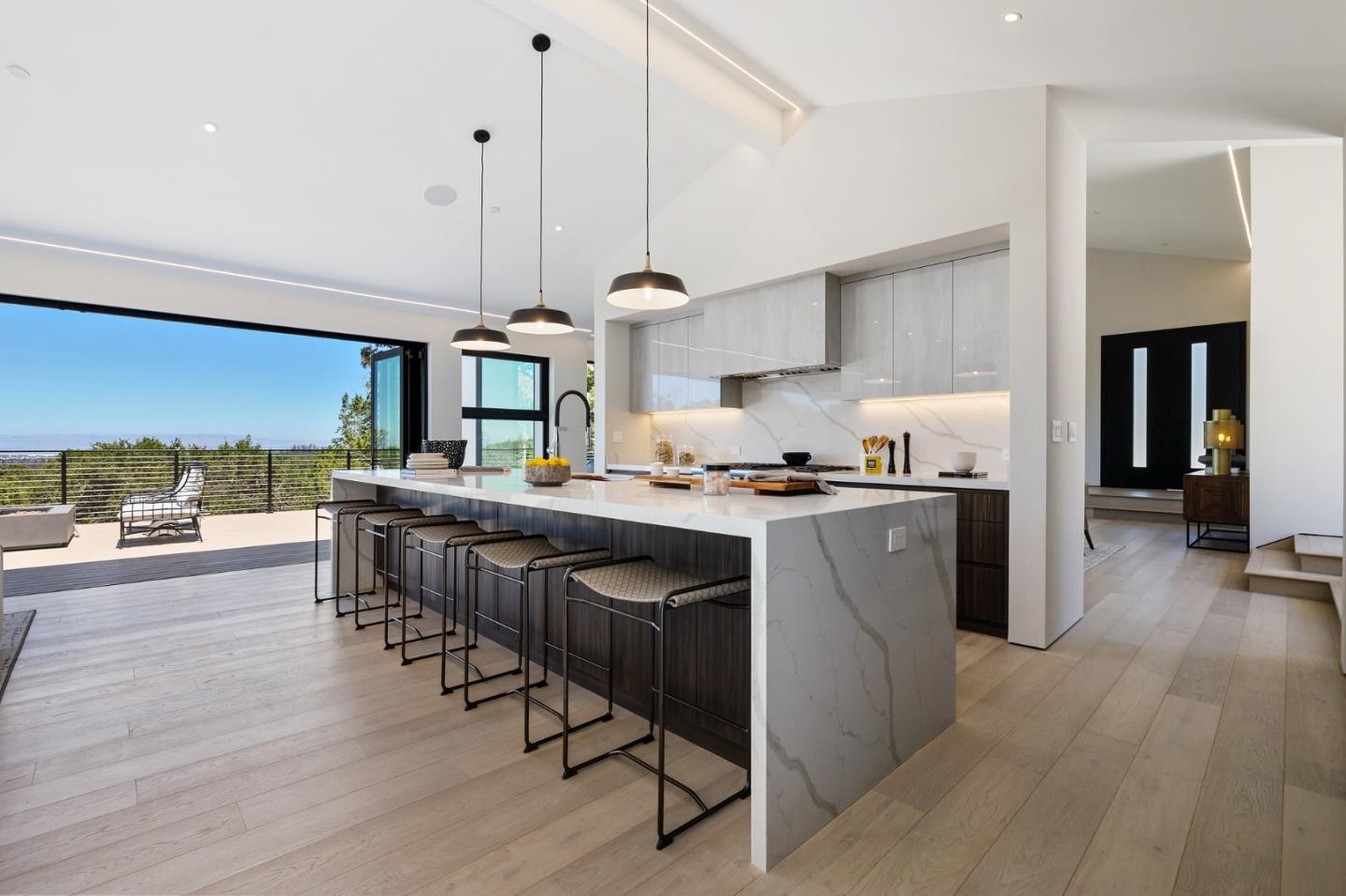 255 Hardwick Road Woodside, CA 94062 - Photo 15 of 90 a kitchen with stainless steel appliances granite countertop a stove a sink dishwasher a refrigerator white cabinets and wooden floor next to a window