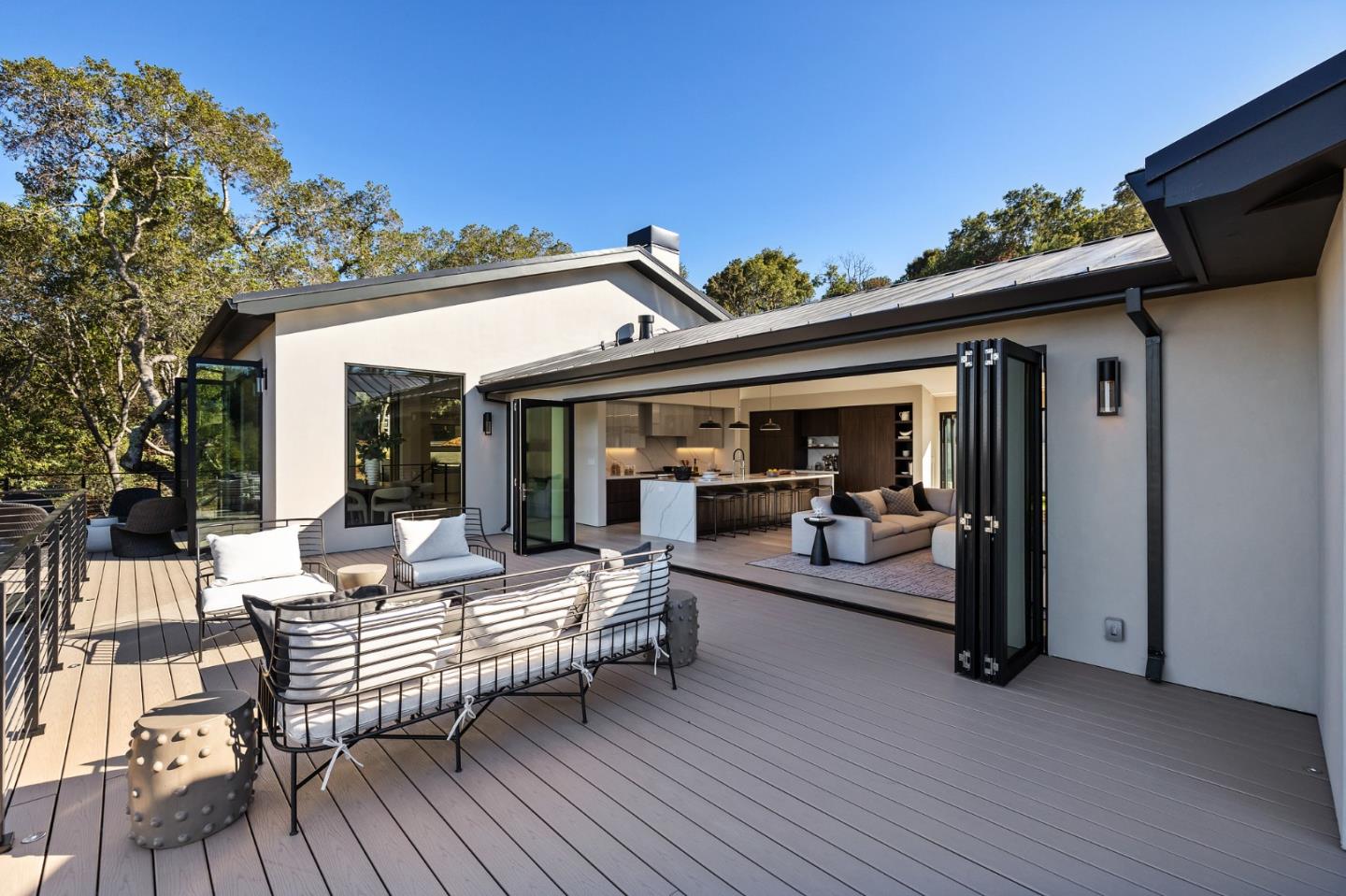 255 Hardwick Road Woodside, CA 94062 - Photo 27 of 90 a view of a patio with table and chairs with wooden floor and fence
