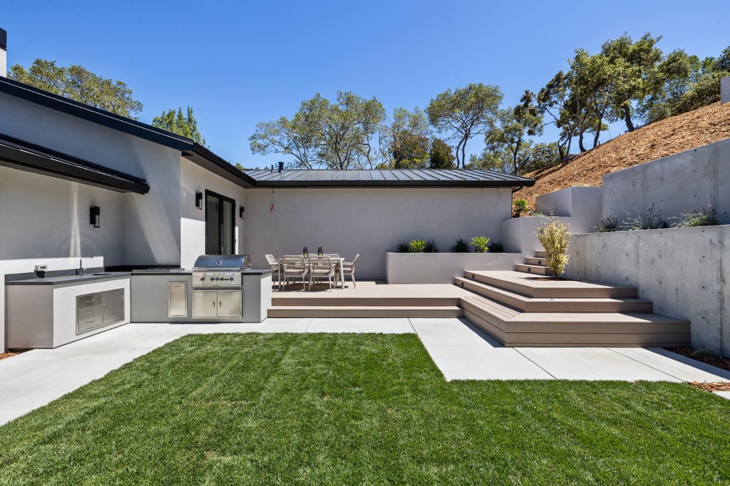 255 Hardwick Road Woodside, CA 94062 - Photo 36 of 90 a view of a patio with couches table and chairs with wooden fence
