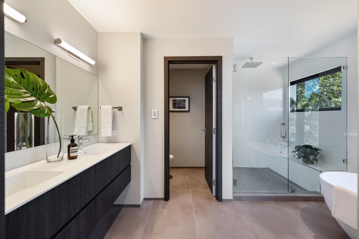 255 Hardwick Road Woodside, CA 94062 - Photo 45 of 90 a en suite bathroom with a double vanity sink a large mirror and a bathtub
