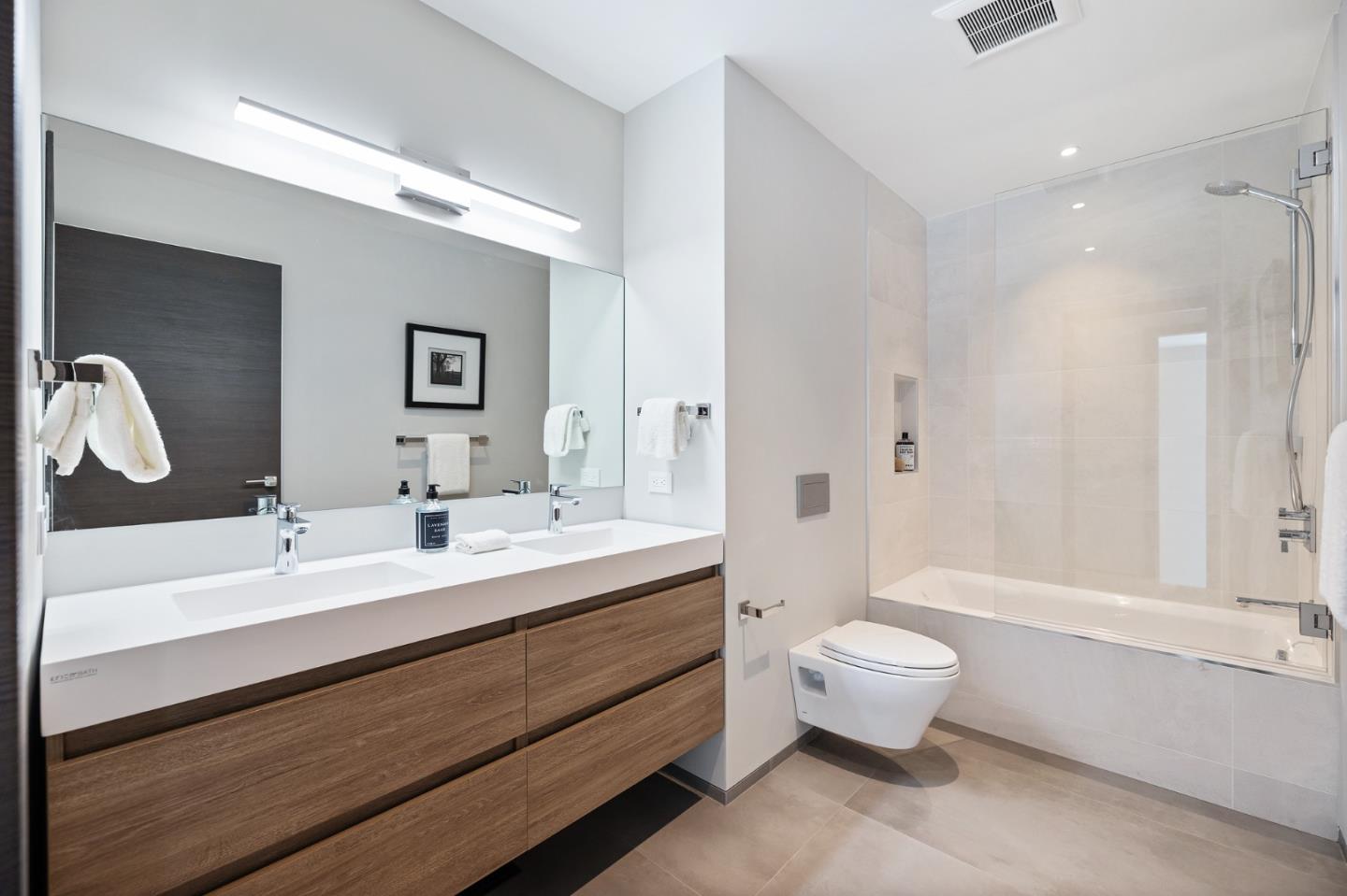 255 Hardwick Road Woodside, CA 94062 - Photo 52 of 90 a bathroom with a double vanity sink toilet mirror and bathtub