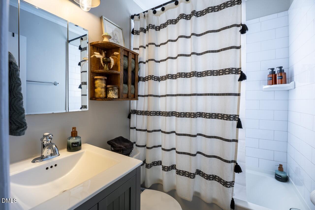 2333 Bernard Street Raleigh, NC 27608 - Photo 7 of 19 a bathroom with a sink toilet and shower