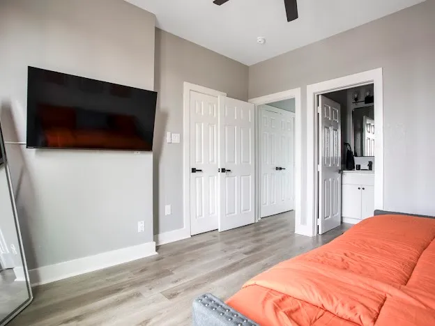 a bedroom with a bed and a flat screen tv