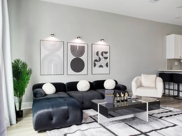 a living room with furniture and a lamp