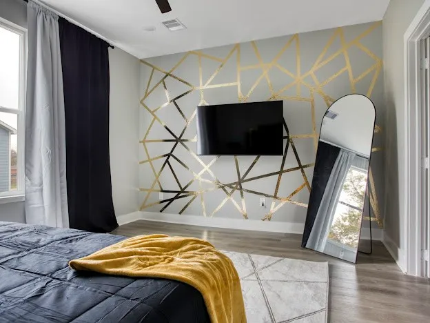 a bedroom with a bed and a flat screen tv