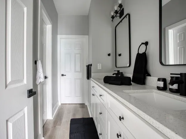 a bathroom with double vanity sink and a mirror