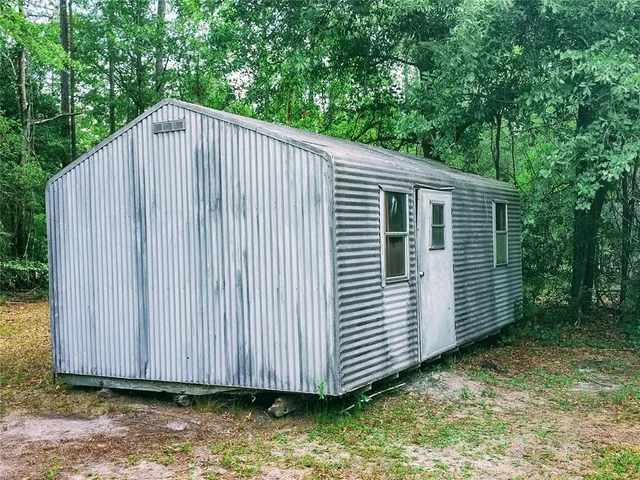 a view of a backyard with wooden floor and roof