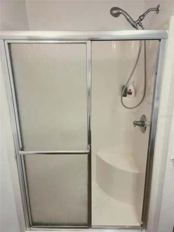 a bathroom with a glass shower door