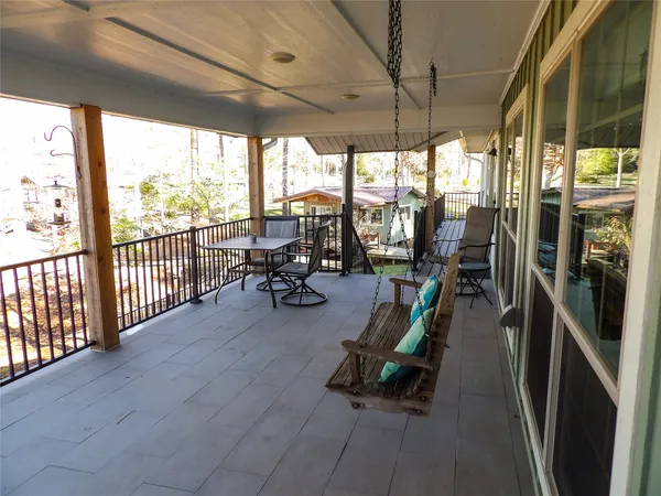 a view of house with backyard outdoor seating and wooden fence
