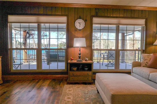 a view of a bedroom with wooden floor and windows