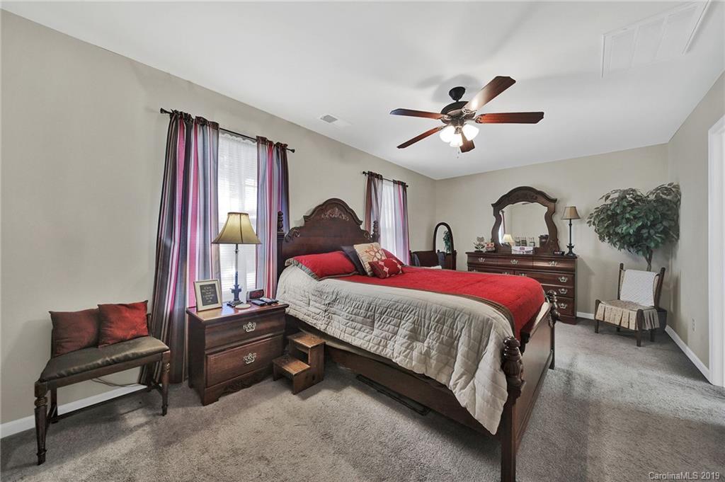 2015 Gunnars Ridge Road, Unit 1/1 Lancaster, SC 29720 - Photo 3 of 19 a bedroom with a bed and a chandelier