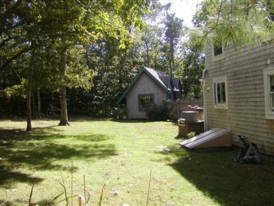 521 Cotuit Road Mashpee, MA 02649 - Photo 6 of 25 a backyard of a house with table and chairs