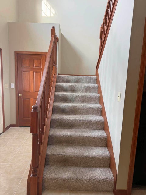 541 North Point Troy, OH 45373 - Photo 2 of 23 This inviting entryway features a grand staircase, offering a warm welcome into the home.