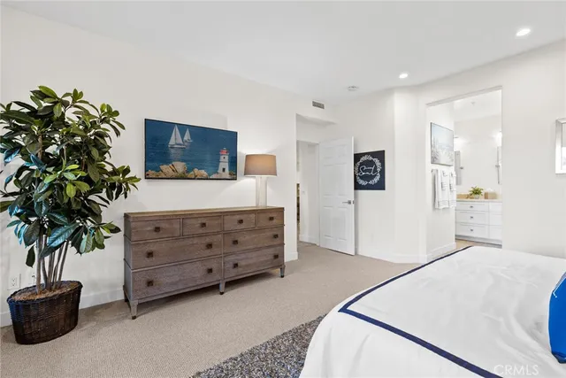 a living room with furniture potted plant and a flat screen tv