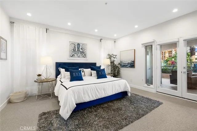 a bedroom with a large bed and a chandelier