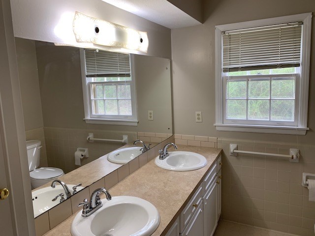 9050 Warm Springs Road Midland, GA 31820 - Photo 2 of 13 a bathroom with a sink double vanity and a toilet