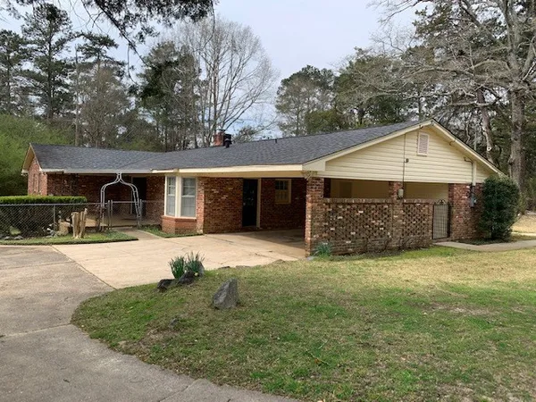 a front view of a house with a garden and porch