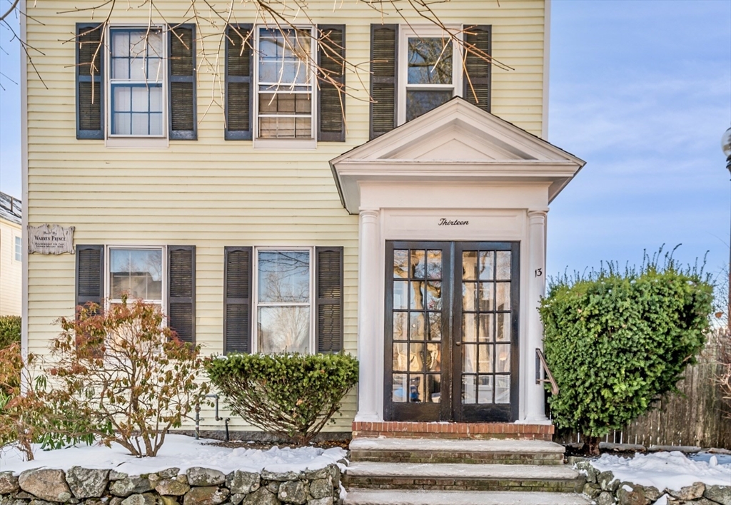 13 Washington Street, Unit 2 Beverly, MA 01915 - Photo 1 of 14 a front view of a house with a yard and potted plants