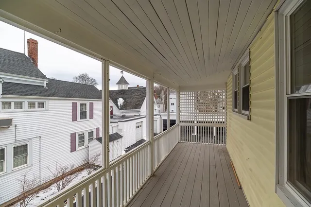 a view of a balcony with wooden floor